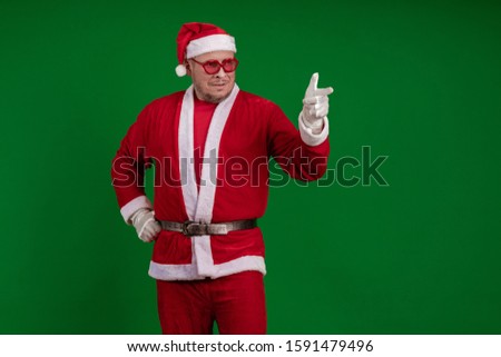 Emotional Santa Claus in pink glasses dances and gestures on a dark red background