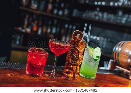 Different alcoholic cocktails on bar table, party drinks 