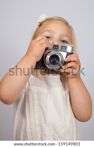 Little girl with photo camera 