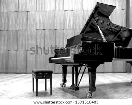 Grand piano set on stage, B&W
