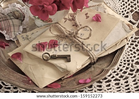 vintage background of old mail with keys on a silver plate