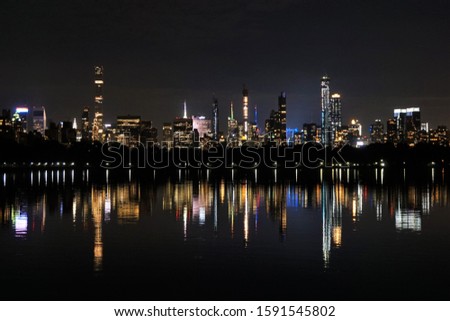 Lights of the Manhattan Skyline Reflecting in a Lake in Central Park. New York, USA