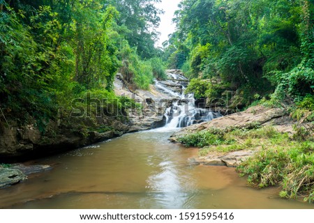 Mae Sa waterfall in Chiang Mai, Thailand. Fresh green maesa waterfall with rock and trees background