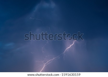 lightning in the night sky overcast flashes of bright light. chain lightning on the dark sky