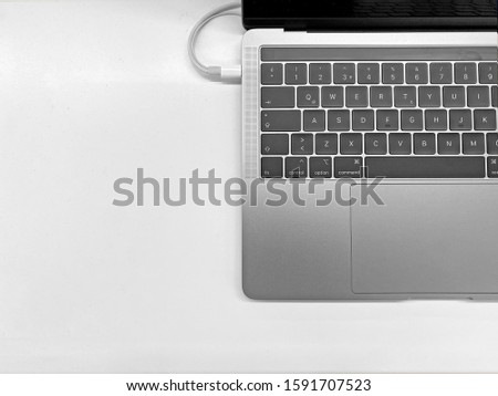 laptop computer keyboard and screen view from the top. space gray latest model laptop. notebook top view on the white background included charge