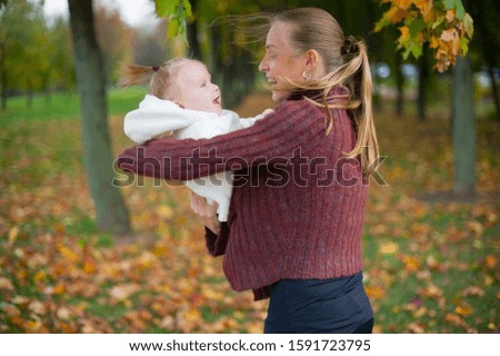 mother with child in the autumn forest for a walk
