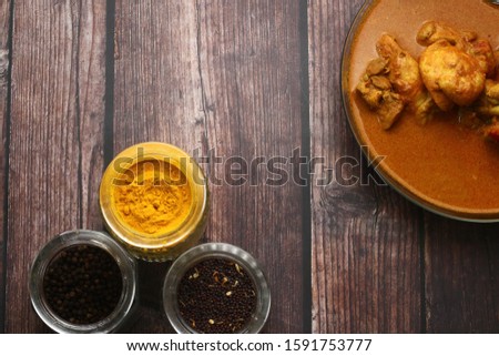 Flat lay of chicken curry and the food ingredient Delicious Asian food cuisine.  Asian food concepts picture. Turmeric, spices and black pepper.