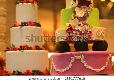 big cakes of three and four floors decorated with berries
