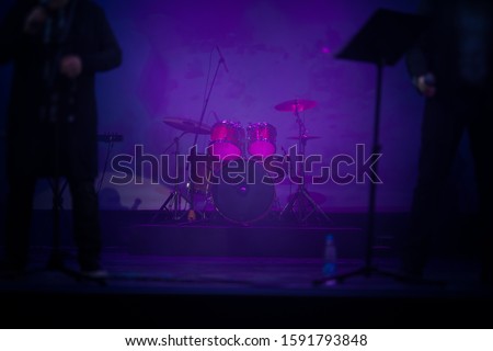 Texture background for design. Stage light and defocus and blur. Musical instruments stand on stage.