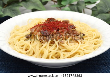 Pasta spaghetti with fresh shimeji mushroom, cream and cheese on table    
