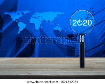 2020 start up flat icon with magnifying glass on wooden table over world map and modern office city tower and skyscraper, Business happy new year 2020 concept, Elements of this image furnished by NASA