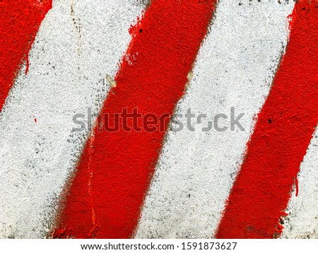 Background striped texture of concrete wall block with white-red stripes. Damaged surface. Post-apocalyptic sign of danger and destroy and construction