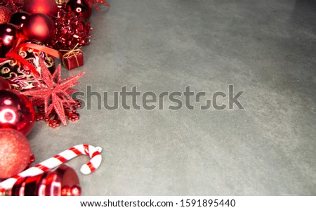 Cluster of Red Christmas Baubles/Balls with Christmas Decorations on a Grey background including Copy Space - Image