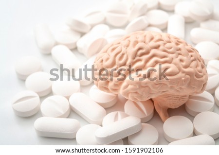 Nootropics use to improve memory and neural function, smart drugs and cognitive enhancers conceptual idea with brain and pills isolated on white background Royalty-Free Stock Photo #1591902106