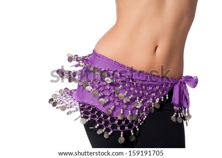 Action shot of the torso of a female belly dancer shaking her hips. She is dressed for rehearsing and practicing belly dance wearing a purple coin belt and black leggings. Isolated on white. Royalty-Free Stock Photo #159191705