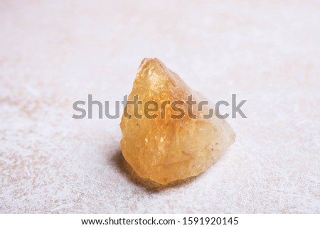 Citrine mineral stone on a white background. The concept of meditation. Royalty-Free Stock Photo #1591920145