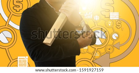 Businessman hold Document roll with circle icon on yellow board with strategy concept design ,white chalk to write business plan on background,with copy space for text.