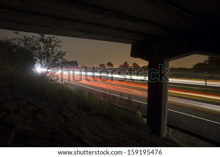 traffic light trails under a bridge