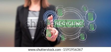 Woman touching a recycling concept on a touch screen with her fingers