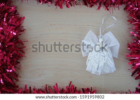   christmas background with white angel, red garland and copy space for text                             