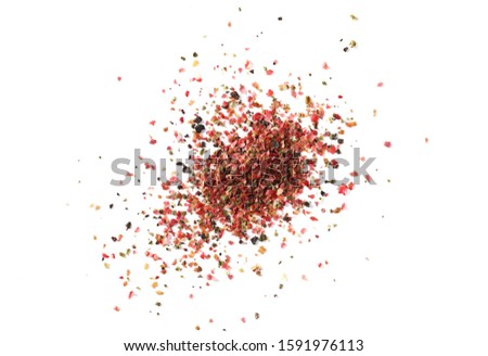 Colorful ground mixed pepper grains, flakes isolated on white background, top view