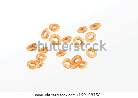 Fried and Spicy Mini Ring Snacks or Fryums (Snacks Pellets) Salty Corn Rings Snack, in a white background. selective focus - Image Royalty-Free Stock Photo #1591987561