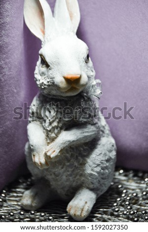 White festive rabbit with a bow on a colored background.