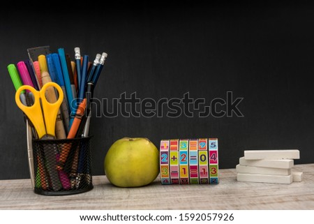 empty notepad on teacher desk against  chalkboard. education concept.