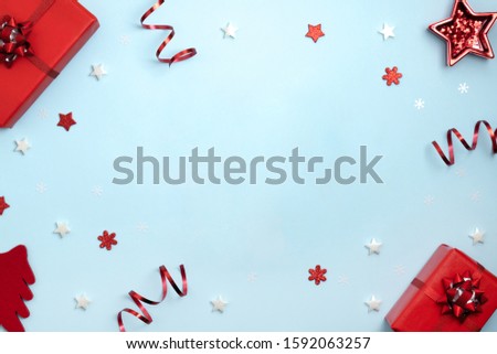 New Year and Christmas frame composition. Christmas toys on pastel blue background. Top view, flat lay, copy space. Template design invitation card.