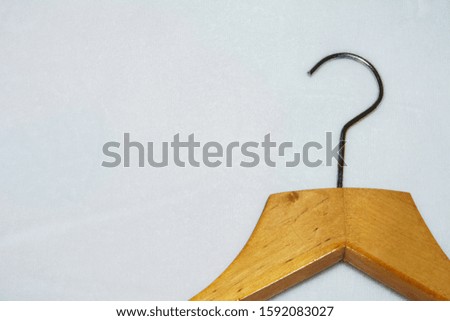 Empty wooden clothes hangers on bright white background. What nothing to wear concept