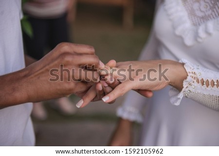 Wedding, exchange of rings. Mixed race couple. Royalty-Free Stock Photo #1592105962