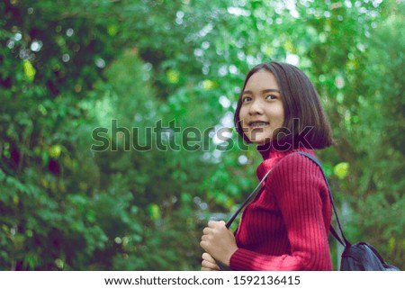 Beautiful young asia girl woth green background .