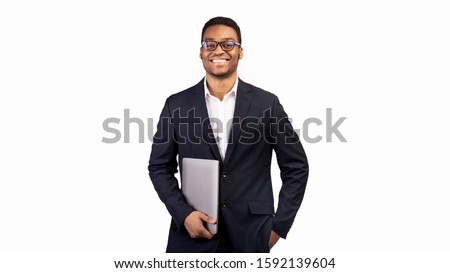 Business Person. Black manager in glasses holding laptop standing over white studio background. Copy space, panorama
