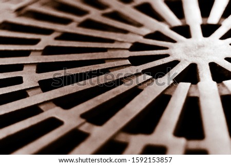 City, old steel textured sewer manhole, metal grunge texture, urban architecture details, background. Steampunk vintage clock bronze element, detail. Abstract hatch cover cast iron design with lines.