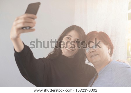 Mother and daughter are taking selfies