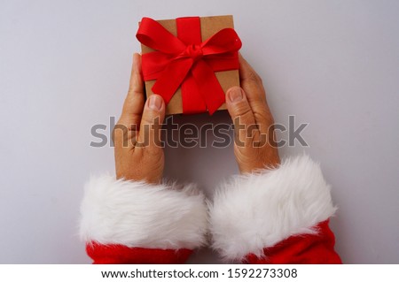 Santa Claus holding gift box. Christmas concept.