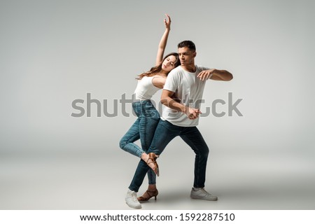 dancers with closed eyes dancing bachata on grey background Royalty-Free Stock Photo #1592287510