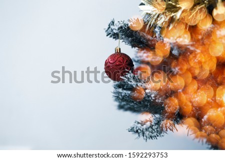 Decorated Christmas tree and light on blurred background.