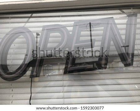 Neon ‘open’ sign in a business window is not turned on