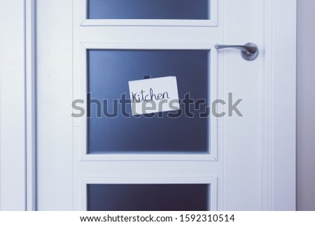 white door with kitchen sign