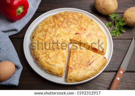 Spanish potato omelette called spanish tortilla. Omelet recipe with potato, egg, onion and red pepper