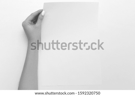 Hand hold blank business card mockup. Female hand holding empty paper isolated on white background. Copy paste image or text.