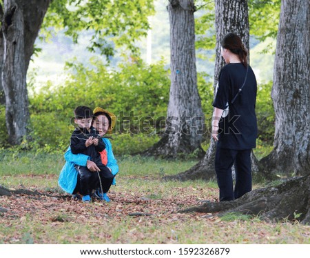 Pictures of grandmother, grandson and mother in tree park together