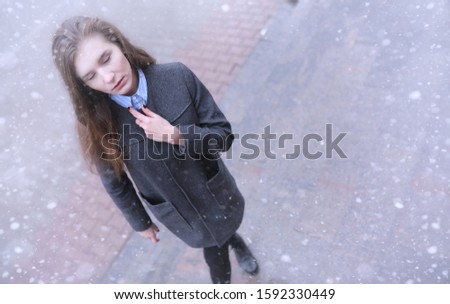 Young girl outdoors in winter. Model girl posing outdoors on a winter day. Festive weekend in the street walking girl.
