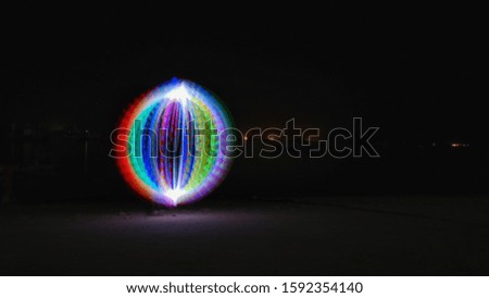 Light painting a rainbow ball on the beach