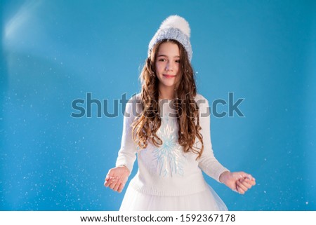 Beautiful fashionable girl girlfriend in hats with snow in winter