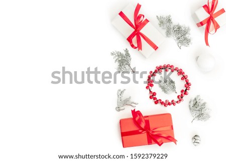 Christmas composition. Gifts, fir tree branches, red decorations on white background. Christmas, winter, new year concept. Happy New Year greeting card. Flat lay, top view, copy space