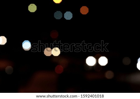 Light spots round multi-colored in the night on a dark background glow, shine. Garland.