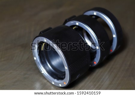 An extension tube also called an extension ring is used with interchangeable lenses to increase magnification. This is most often used in macro photography.
