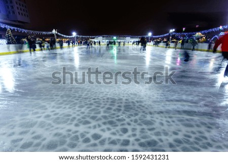 people ride on a night skating rink, long exposure